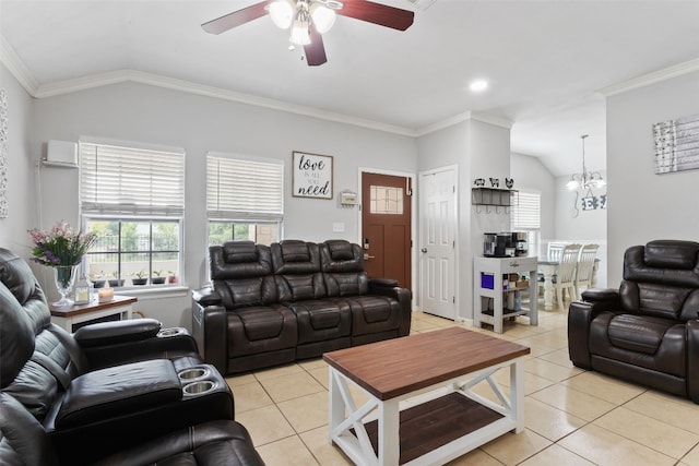 living area featuring light tile patterned floors, a wealth of natural light, lofted ceiling, and ceiling fan with notable chandelier