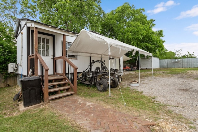 view of outdoor structure with fence and an outbuilding