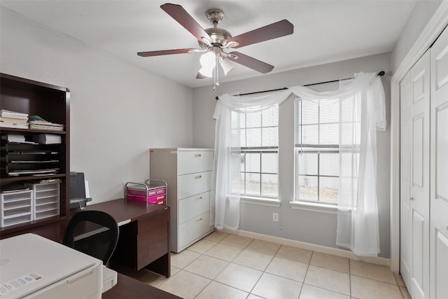 office area featuring light tile patterned floors, a ceiling fan, and baseboards