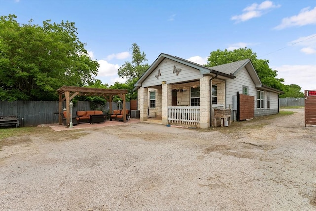bungalow featuring a pergola, cooling unit, outdoor lounge area, stone siding, and fence