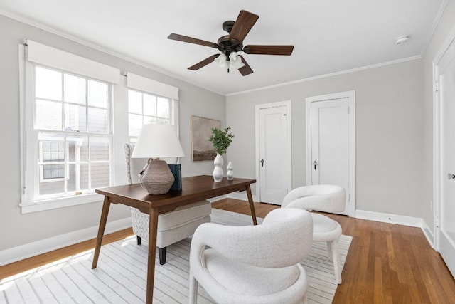 office area with wood finished floors, a ceiling fan, crown molding, and baseboards