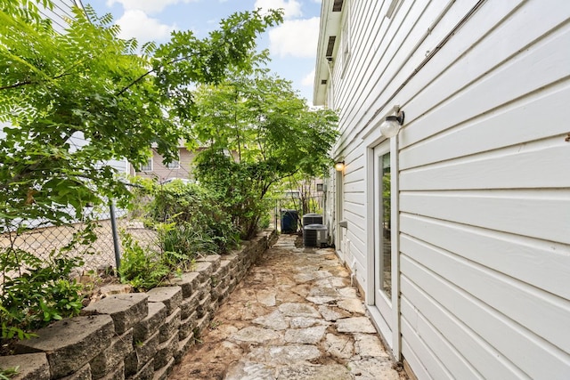 view of home's exterior featuring fence and central AC unit