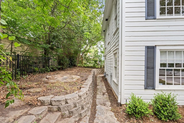 view of property exterior featuring fence