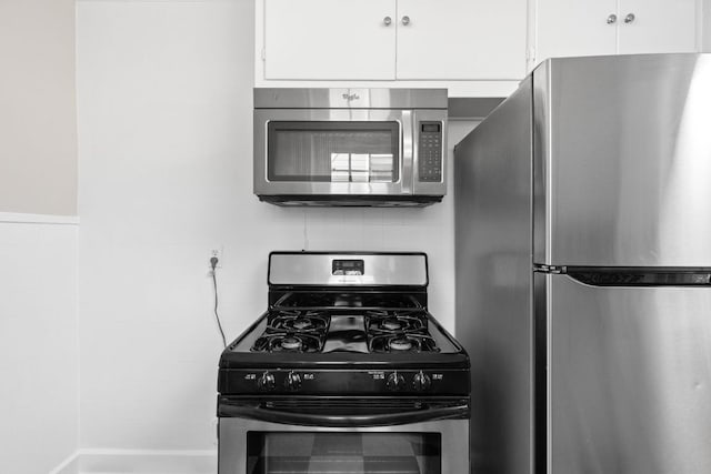 kitchen featuring white cabinetry and appliances with stainless steel finishes
