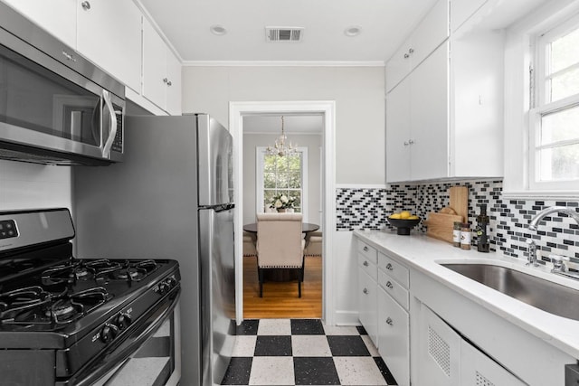 kitchen featuring appliances with stainless steel finishes, visible vents, a healthy amount of sunlight, and light floors