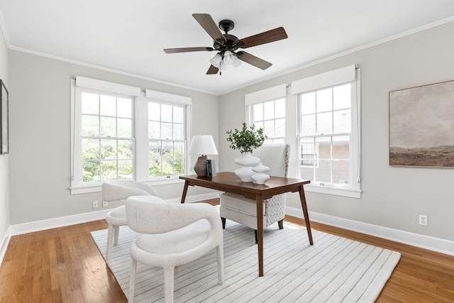 office with baseboards, ceiling fan, crown molding, and light wood finished floors