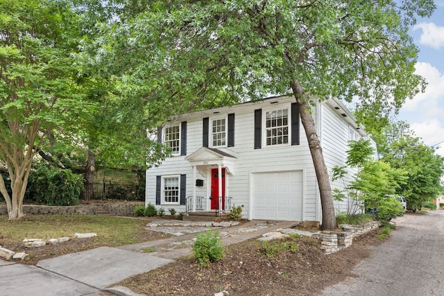 colonial home featuring concrete driveway and a garage