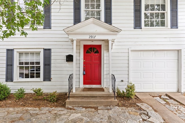 view of exterior entry with an attached garage