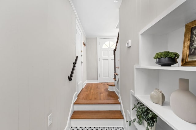 stairs featuring wood finished floors