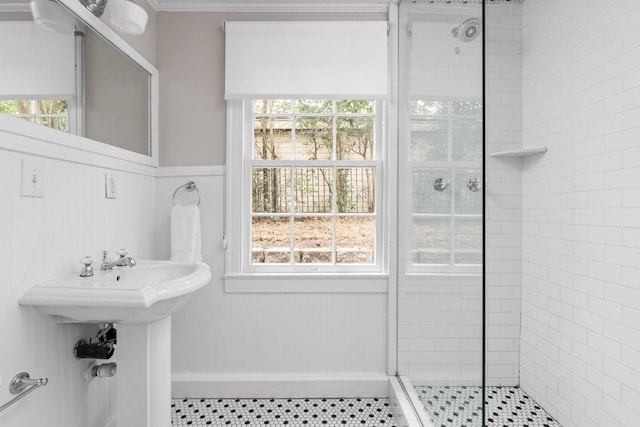full bath with crown molding, a stall shower, and a healthy amount of sunlight