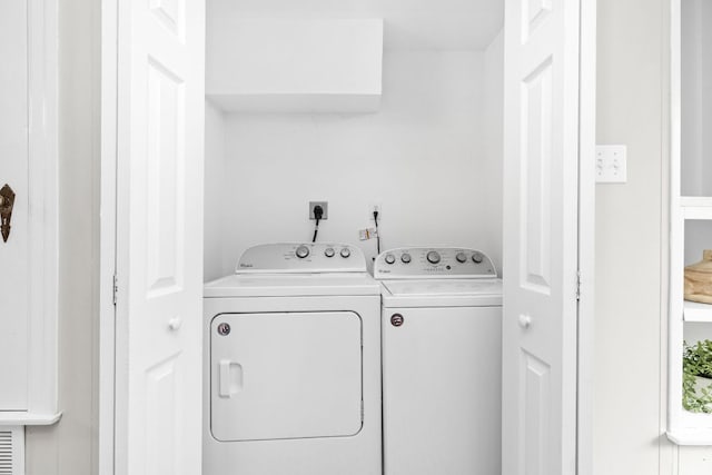 laundry area featuring separate washer and dryer and laundry area