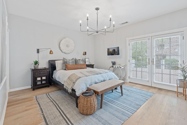129 The Hills Dr, The Hills, TX 78738 - bedroom with access to outside, a chandelier, light wood-style flooring, and baseboards