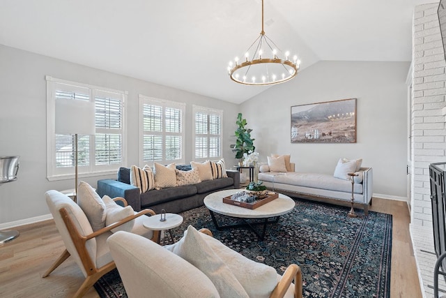 129 The Hills Dr, The Hills, TX 78738 - living room featuring wood finished floors, a chandelier, plenty of natural light, and lofted ceiling
