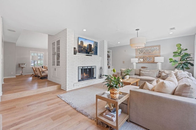 129 The Hills Dr, The Hills, TX 78738 - living room featuring light wood-style floors, a fireplace, and recessed lighting