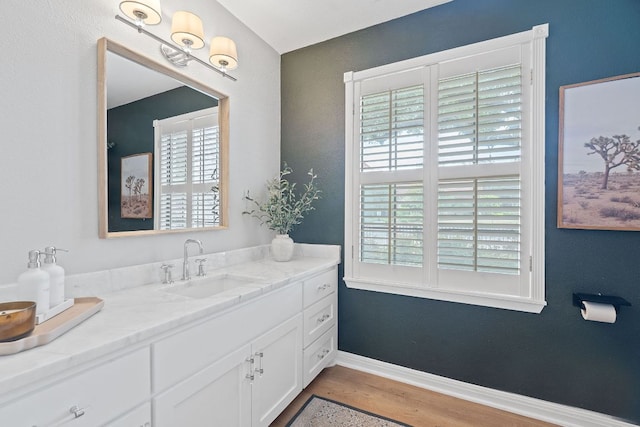 129 The Hills Dr, The Hills, TX 78738 - bathroom featuring vanity, wood finished floors, and baseboards