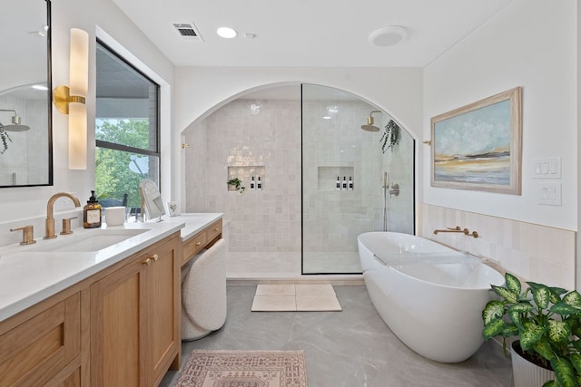129 The Hills Dr, The Hills, TX 78738 - full bath featuring walk in shower, vanity, and a freestanding tub