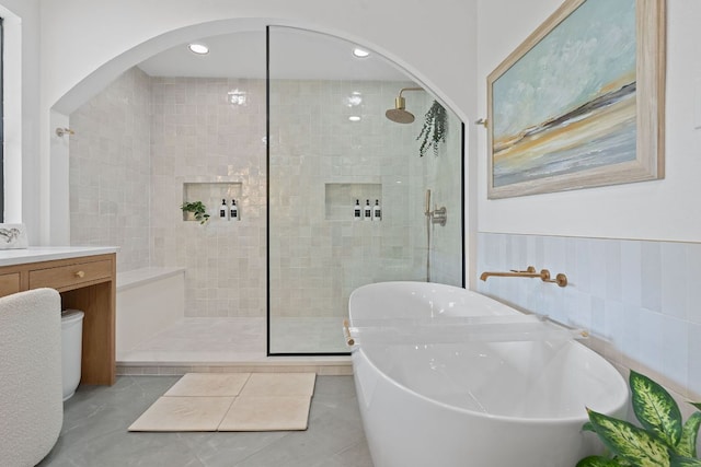 129 The Hills Dr, The Hills, TX 78738 - full bathroom featuring walk in shower, a freestanding bath, vanity, tile patterned flooring, and recessed lighting