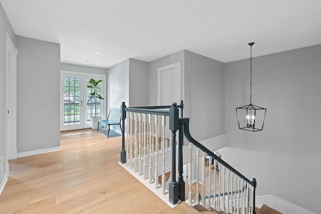 129 The Hills Dr, The Hills, TX 78738 - hall with an upstairs landing, a chandelier, baseboards, light wood-type flooring, and recessed lighting