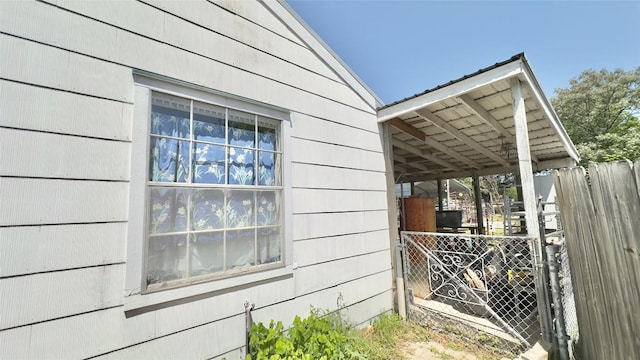view of side of home featuring fence
