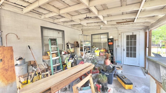interior space with beamed ceiling and concrete floors