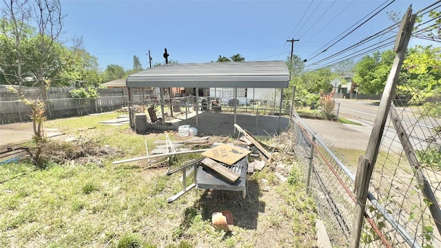 view of yard featuring fence and a detached carport