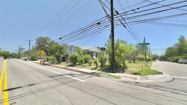 view of street with traffic signs, sidewalks, and curbs