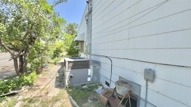 view of side of home with central air condition unit