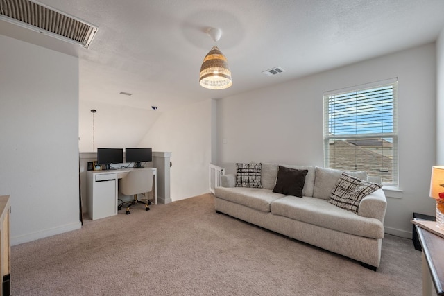 living room featuring baseboards, visible vents, and light colored carpet