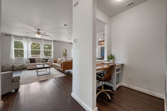 living room with visible vents, a ceiling fan, dark wood finished floors, and baseboards