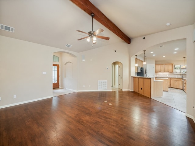 2912 Norton Ave, Lago Vista, TX 78645 - unfurnished living room with a ceiling fan, arched walkways, and healthy amount of natural light