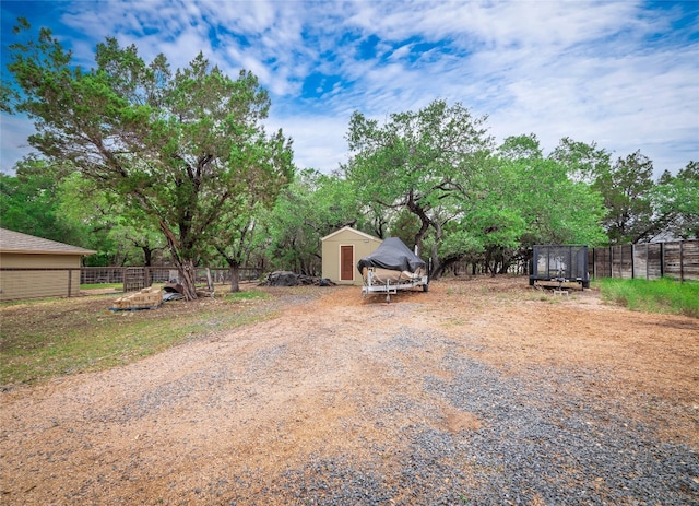 2912 Norton Ave, Lago Vista, TX 78645 - view of yard featuring a storage shed and view of scattered trees
