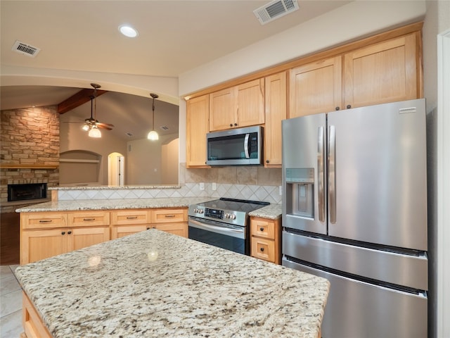 2912 Norton Ave, Lago Vista, TX 78645 - kitchen with appliances with stainless steel finishes, light brown cabinetry, tasteful backsplash, ceiling fan, and a peninsula