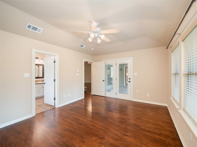 2912 Norton Ave, Lago Vista, TX 78645 - unfurnished bedroom featuring wood finished floors, ensuite bath, lofted ceiling, and a ceiling fan
