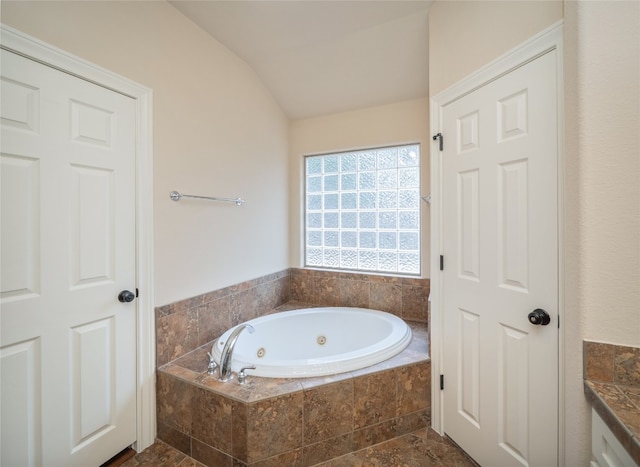2912 Norton Ave, Lago Vista, TX 78645 - full bath with a tub with jets, vaulted ceiling, and vanity