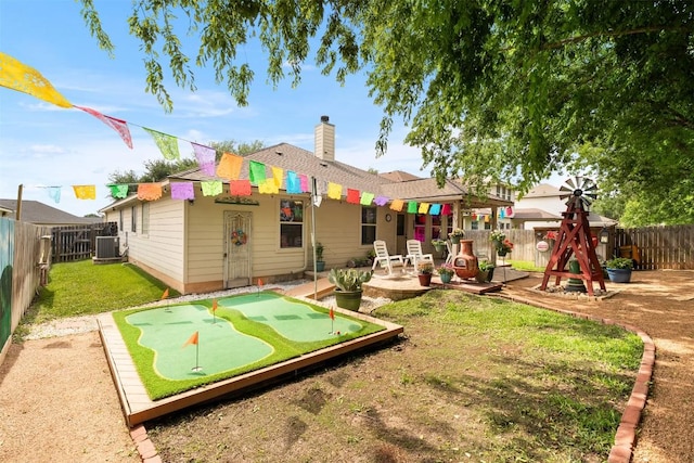 30310 Bumble Bee Dr, Georgetown, TX 78628 - rear view of property with a fenced backyard, a chimney, a patio area, a lawn, and central air condition unit