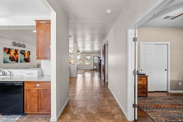 30310 Bumble Bee Dr, Georgetown, TX 78628 - hallway with visible vents, baseboards, and light tile patterned floors