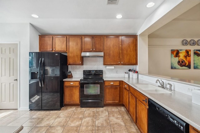 30310 Bumble Bee Dr, Georgetown, TX 78628 - kitchen featuring a sink, light countertops, brown cabinetry, under cabinet range hood, and black appliances