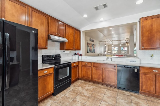 30310 Bumble Bee Dr, Georgetown, TX 78628 - kitchen featuring a sink, light countertops, under cabinet range hood, visible vents, and black appliances