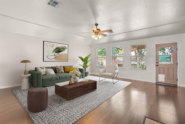 30310 Bumble Bee Dr, Georgetown, TX 78628 - living room featuring ceiling fan, visible vents, wood finished floors, baseboards, and a wealth of natural light