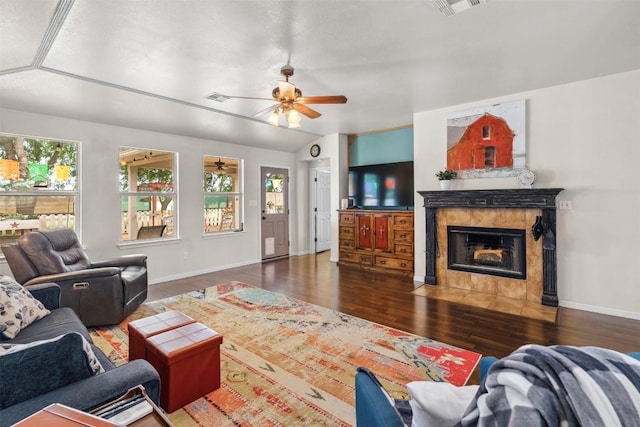 30310 Bumble Bee Dr, Georgetown, TX 78628 - living area featuring baseboards, ceiling fan, wood finished floors, and a tile fireplace