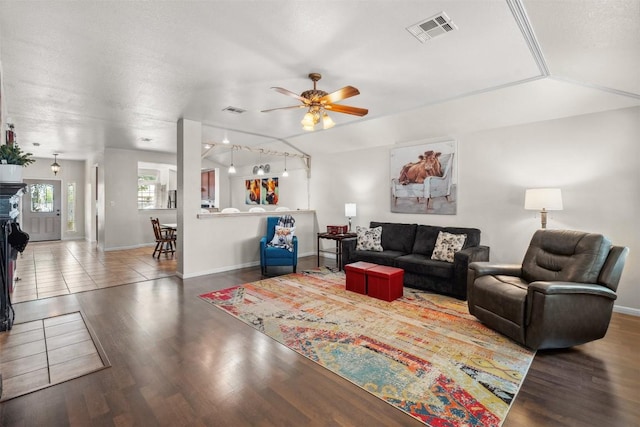 30310 Bumble Bee Dr, Georgetown, TX 78628 - living area featuring baseboards, a ceiling fan, wood finished floors, and visible vents