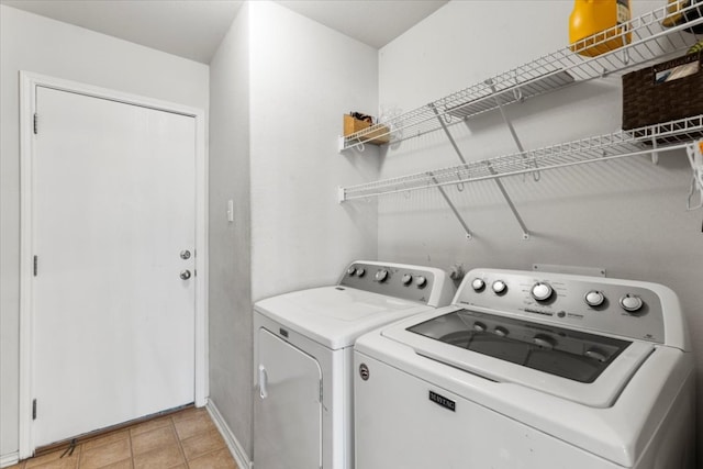 107 Jefferson Cv, Elgin, TX 78621 - washroom featuring washer and clothes dryer, baseboards, light tile patterned flooring, and laundry area