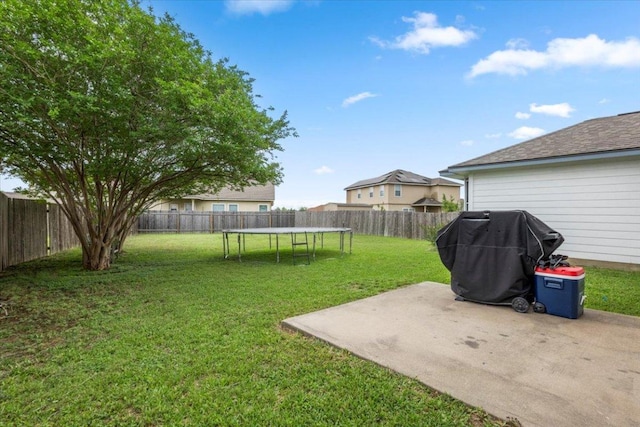 107 Jefferson Cv, Elgin, TX 78621 - view of yard with a trampoline, a fenced backyard, and a patio area