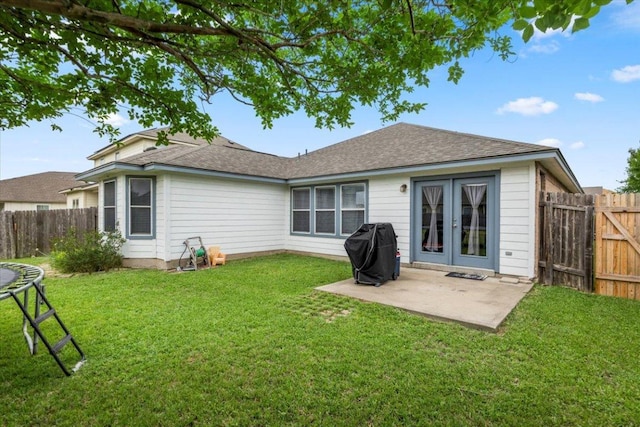 107 Jefferson Cv, Elgin, TX 78621 - back of property with a lawn, french doors, a fenced backyard, and a patio area
