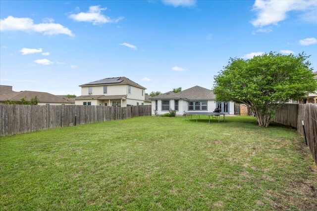 107 Jefferson Cv, Elgin, TX 78621 - view of yard with a trampoline and a fenced backyard