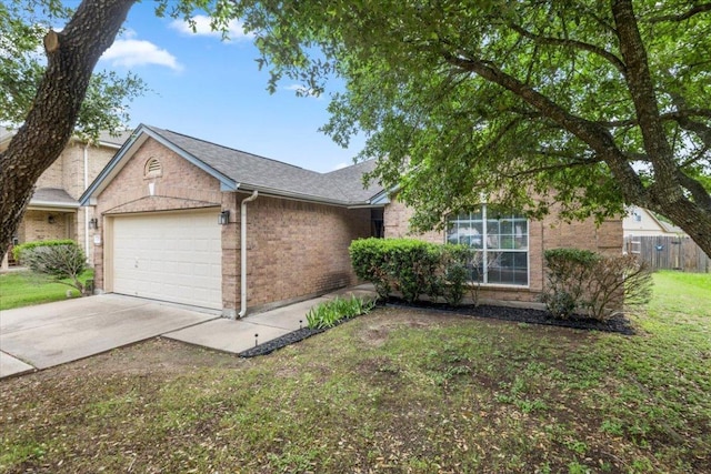 107 Jefferson Cv, Elgin, TX 78621 - ranch-style home with a front yard, driveway, brick siding, an attached garage, and fence