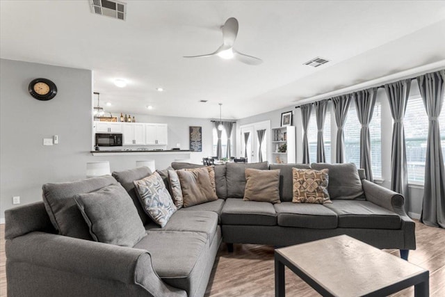 107 Jefferson Cv, Elgin, TX 78621 - living room featuring visible vents, ceiling fan, and light wood-style floors