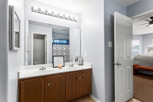 107 Jefferson Cv, Elgin, TX 78621 - ensuite bathroom featuring double vanity, a sink, connected bathroom, and baseboards