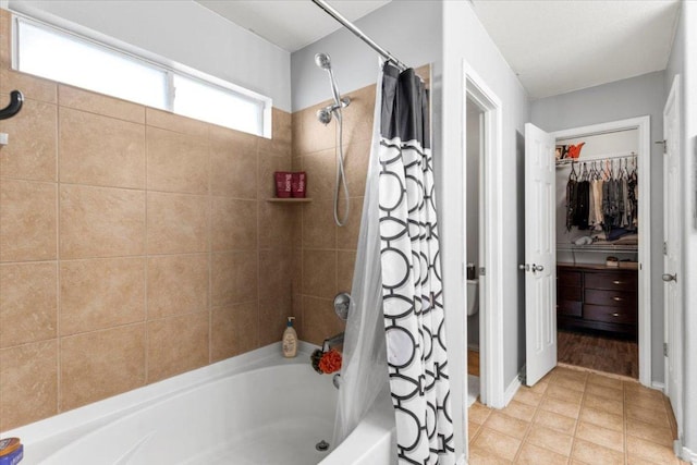 107 Jefferson Cv, Elgin, TX 78621 - full bathroom with shower / bath combination with curtain, a walk in closet, and tile patterned floors