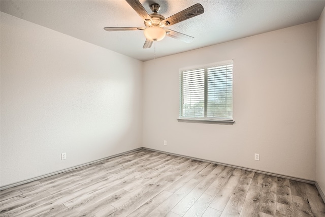8201 Georgie Trace Ave, Austin, TX 78747 - unfurnished room featuring ceiling fan, light wood-style flooring, and a textured ceiling